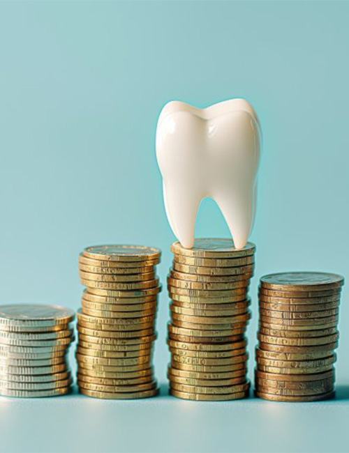 a tooth atop a stack of coins