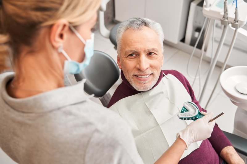 a patient visiting his dentist for dentures